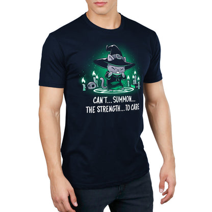 Premium Cotton T-shirt_TeeTurtle Can't Summon The Strength To Care Navy Blue t-shirt featuring a grey cat in a black witch's hat and black robe struggling to cast a spell. It's standing in a summoning circle with candles, a scull, and a book around it. It is surrounded by a green glow. Text underneath it says "Can't... summon... the strength... to care"