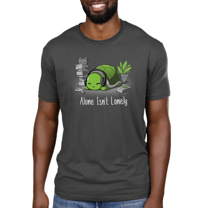 Premium Cotton T-shirt_TeeTurtle Alone Isn't Lonely charcoal gray t-shirt featuring a comfy-looking turtle with headphones laying by a plant, books, a cat, and video game items.