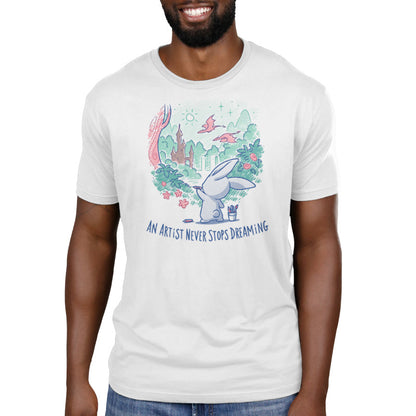 Premium Cotton T-shirt_TeeTurtle An Artist Never Stops Dreaming white t-shirt featuring a bunny painting a whimsical landscape with a castle, trees, and flying creature.