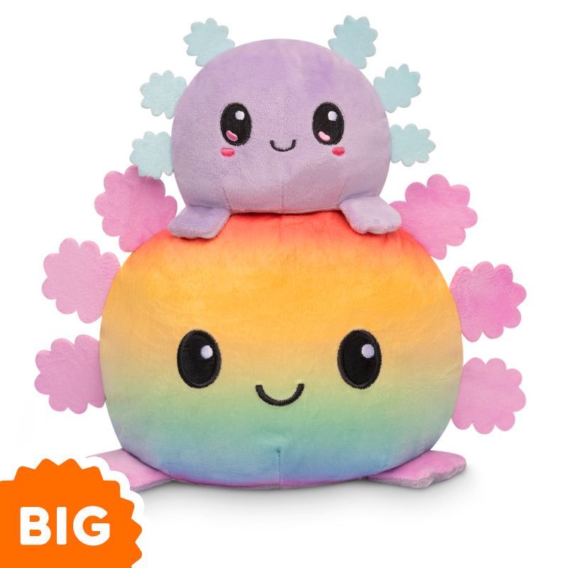 Two Big Reversible Axolotl Plushies by TeeTurtle sitting on top of each other.