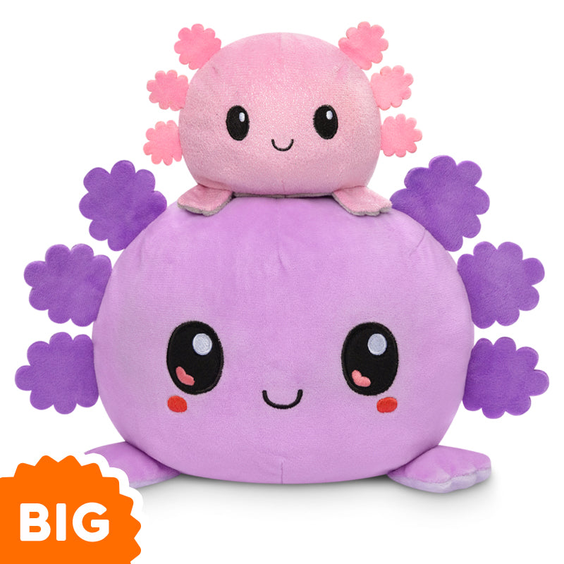 A TeeTurtle Big Reversible Axolotl Plushie (Purple + Light Purple) sitting on top of a small pink and purple reversible axolotl.