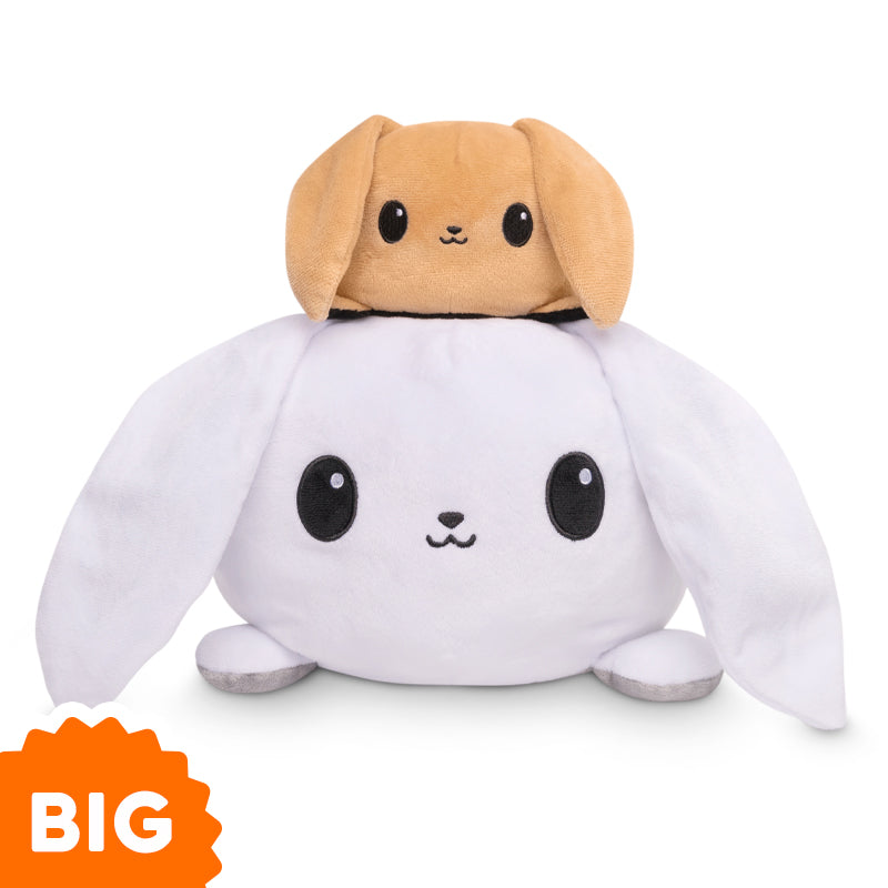 A TeeTurtle Big Reversible Bunny Plushie is stacked on top of another bunny.