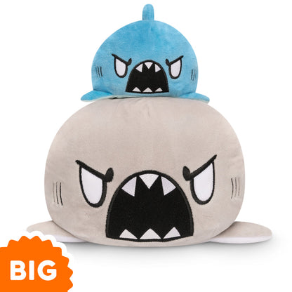 Two Big Reversible Narwhal & Shark Plushies from TeeTurtle stacked on top of each other.