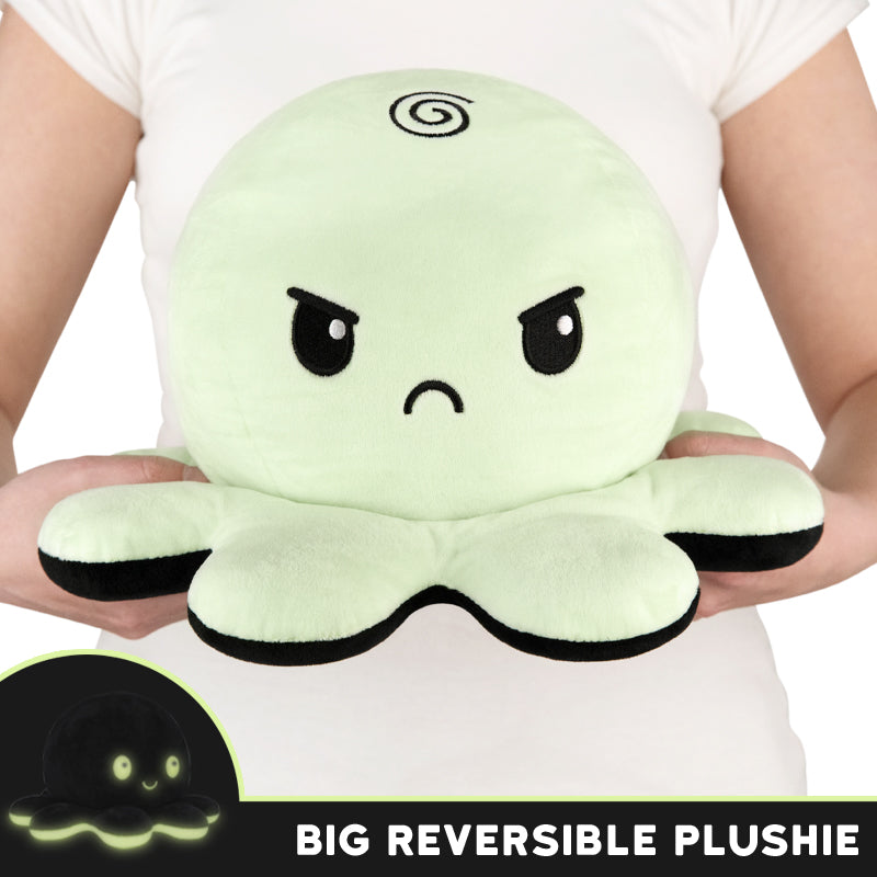 A TeeTurtle TeeTurtle Big Reversible Octopus Plushie (Green Glow + Black) green octopus shaped plush with the words big reversible plush.