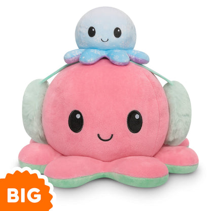 A pink and green TeeTurtle Big Reversible Octopus Plushie is stacked on top of another octopus.