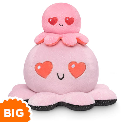 A pink Big Reversible Octopus Plushie with hearts on top of it, perfect for TeeTurtle enthusiasts.