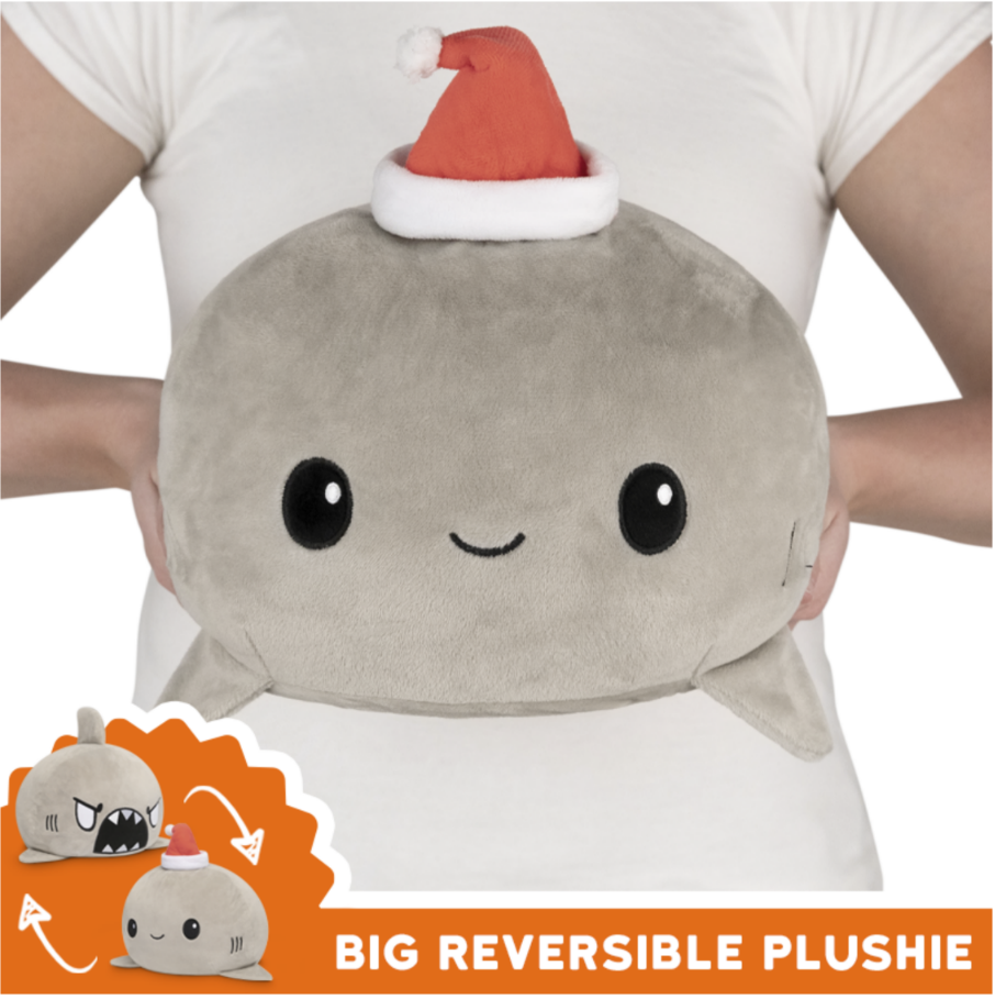 A TeeTurtle Big Reversible Shark Plushie with a santa hat on it.