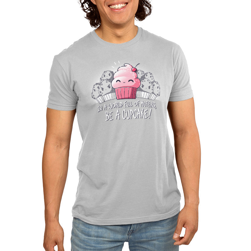 Premium Cotton T-shirt_TeeTurtle Be a Cupcake silver gray t-shirt featuring a cheerful pink cartoon cupcake with a cherry on top smiling among angry muffins, captioned "In a world full of muffins, be a cupcake!" in this food design.