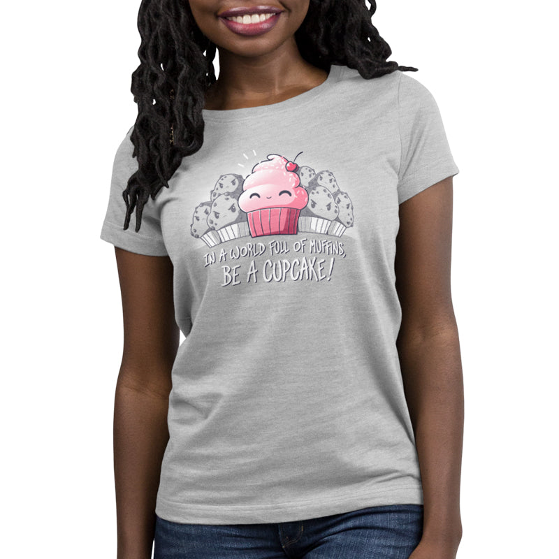 Premium Cotton T-shirt_TeeTurtle Be a Cupcake silver gray t-shirt featuring a cheerful pink cartoon cupcake with a cherry on top smiling among angry muffins, captioned "In a world full of muffins, be a cupcake!" in this food design.