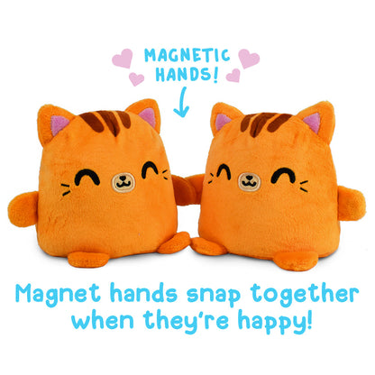 Two TeeTurtle Reversible Cat Plushmates with magnetic hands that snap together when they're happy.