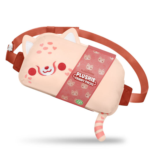 The Plushiverse Wild About You Cheetah Plushie Fanny Pack by TeeTurtle is designed like a cute, blushing cat with ears, a tail, and a happy expression. The pack features hands-free functionality and an adjustable belt in a pink and red color scheme with a tag that reads 