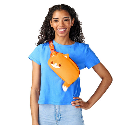 A smiling woman wearing a blue t-shirt with a Plushiverse Feeling Foxy Plushie Fanny Pack by TeeTurtle.