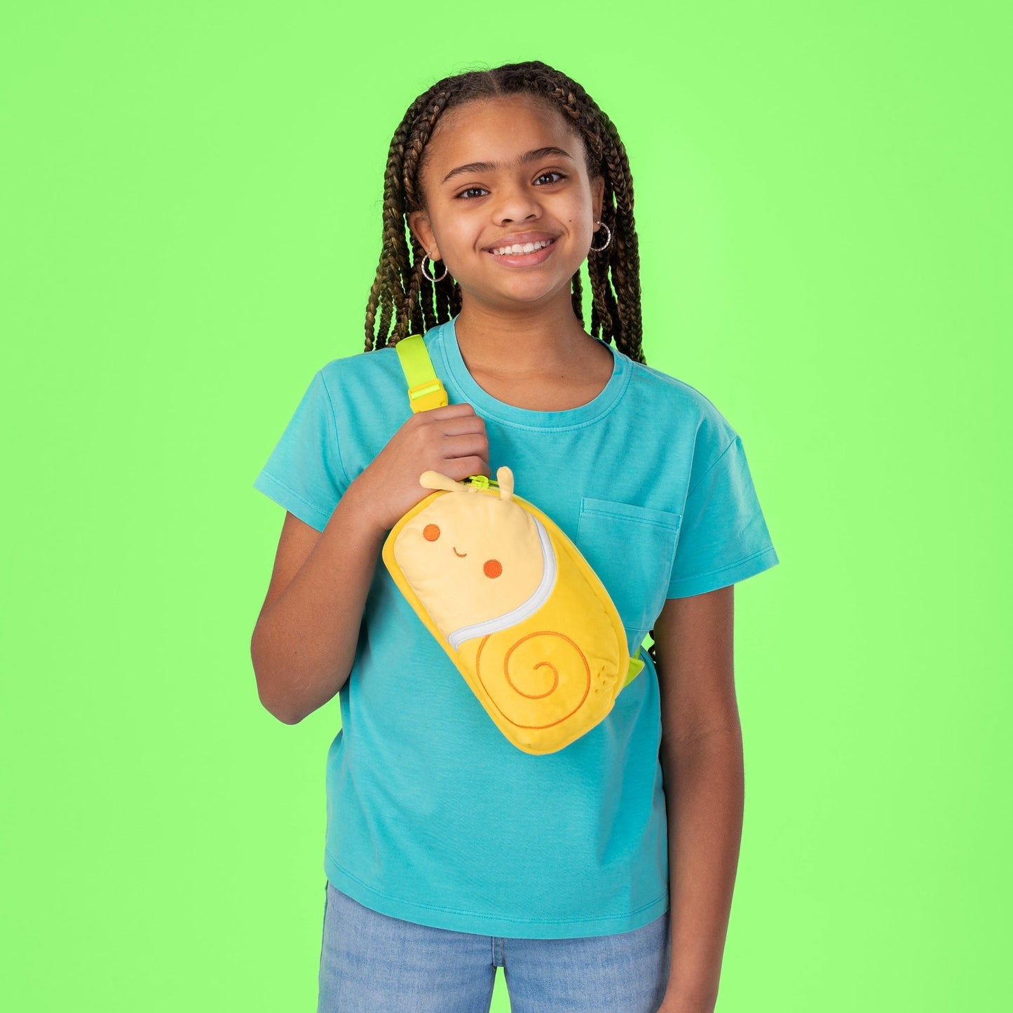 A young girl with a TeeTurtle Plushiverse Swirly Snail Plushie Fanny Pack slung over her shoulder.