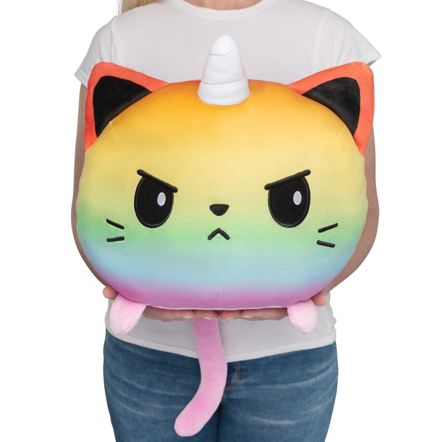 A woman cuddling a TeeTurtle Giant Moody Kittencorn Plushie.