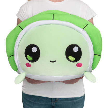 A woman cuddling a TeeTurtle Giant Moody Turtle plushie.