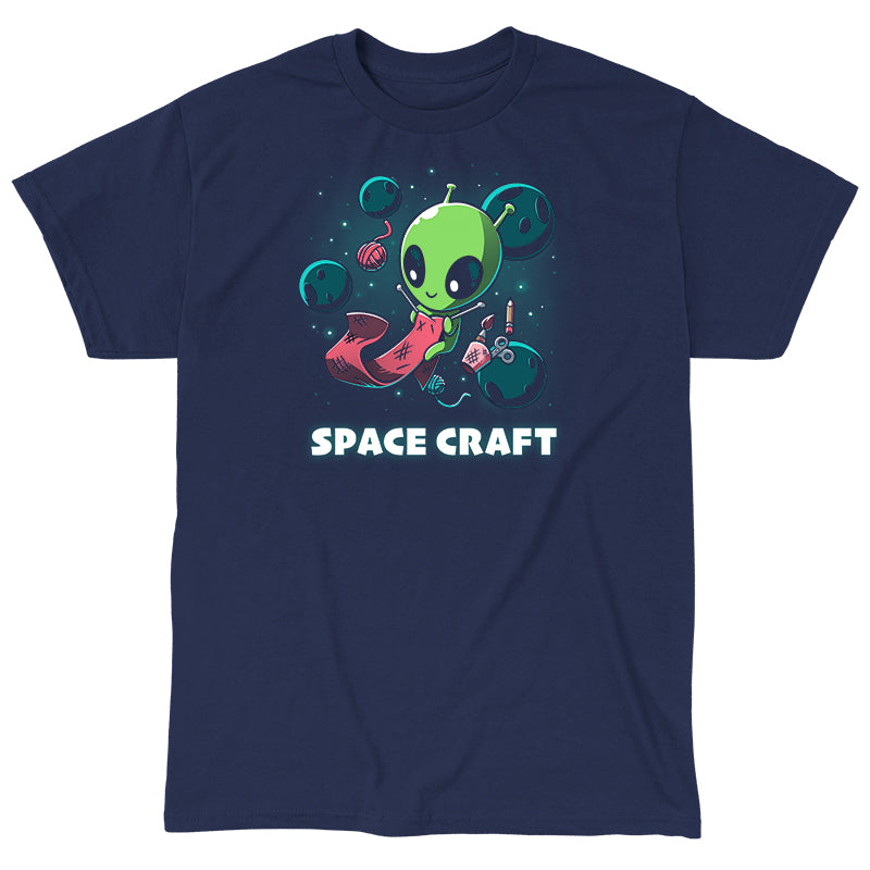 Classic Cotton T-shirt_TeeTurtle Space Craft navy blue t-shirt featuring an illustration of a green alien knitting a red scarf in space surrounded by planets, stars, balls of yarn, and a cup holding scissors, a paint brush and floating pencil. The words "SPACE CRAFT" are written below.