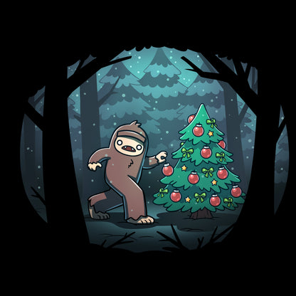 Long Sleeve T-shirt_TeeTurtle black Bigfoot Christmas apparel featuring a sasquatch caught putting holiday decor on a tree in the middle of a snowy forest.