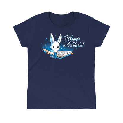 Classic Cotton T-shirt_Teeturtle Books are Bigger on the Inside Navy Blue t-shirt featuring a white rabbit reading a book from which light and sparkles are coming out with a blue ribbon bookmark marking the page with the text "It's bigger on the inside!" written next to it.