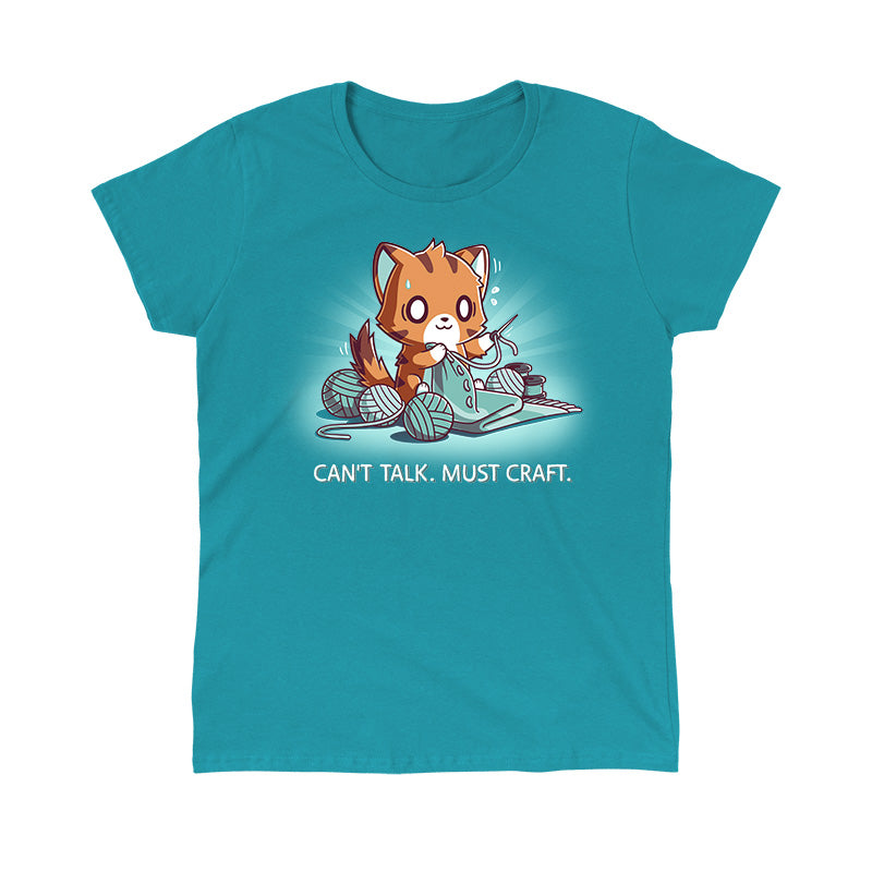 Classic Cotton T-shirt_TeeTurtle Can't Talk. Must Craft tropical blue t-shirt featuring a cat knitting with multiple yarn balls around and a concentrated expression. Text below reads "CAN'T TALK. MUST CRAFT."