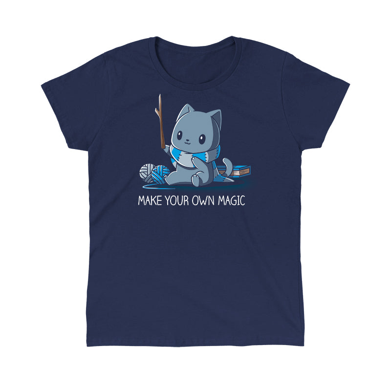 Classic Cotton T-shirt_Teeturtle Make Your Own Magic Navy Blue Featuring a gray cat sitting in front of a book next to yarn with a wand-like stick and a crafted scarf with the text 'Make Your Own Magic' below.