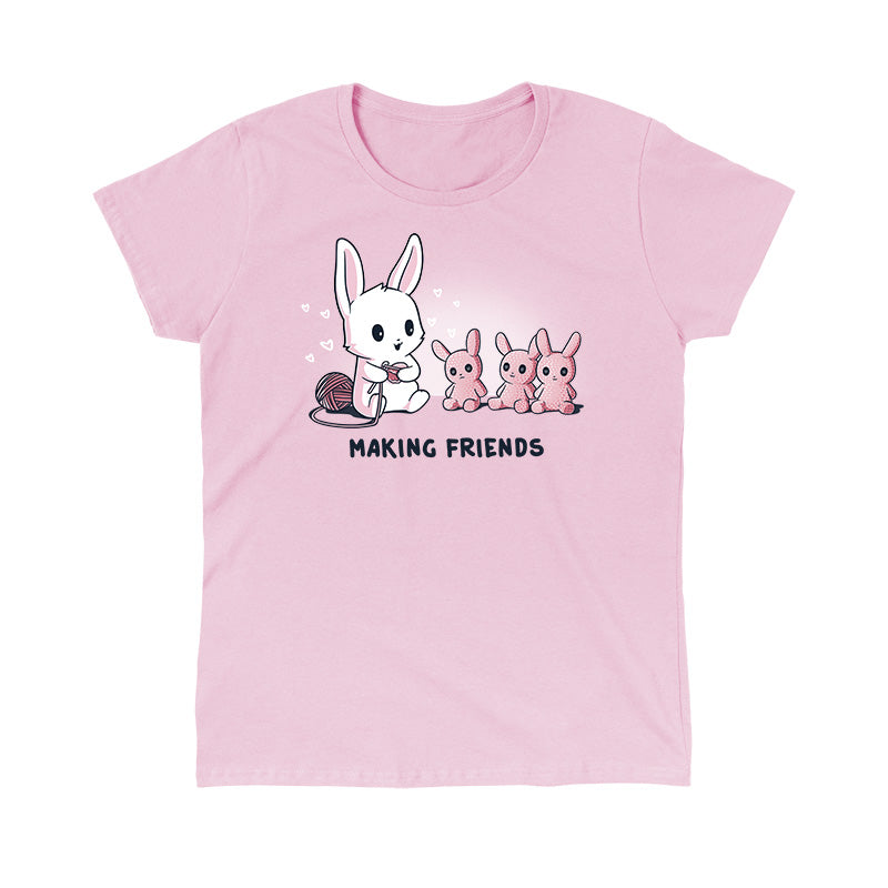 Classic Cotton T-shirt_Teeturtle Making Friends light Pink t-shirt Featuring a white-furred bunny knitting bunny friends out of yarn.