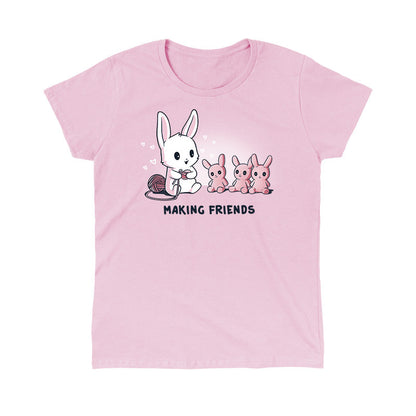 Classic Cotton T-shirt_Teeturtle Making Friends light Pink t-shirt Featuring a white-furred bunny knitting bunny friends out of yarn.