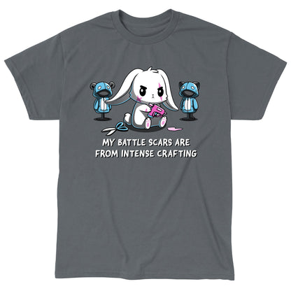 Classic Cotton T-shirt_TeeTurtle Battle Scars charcoal gray t-shirt featuring a determined cartoon rabbit holding a hot glue gun, surrounded by sewing supplies and mannequins, with the text "My battle scars are from intense crafting" below.