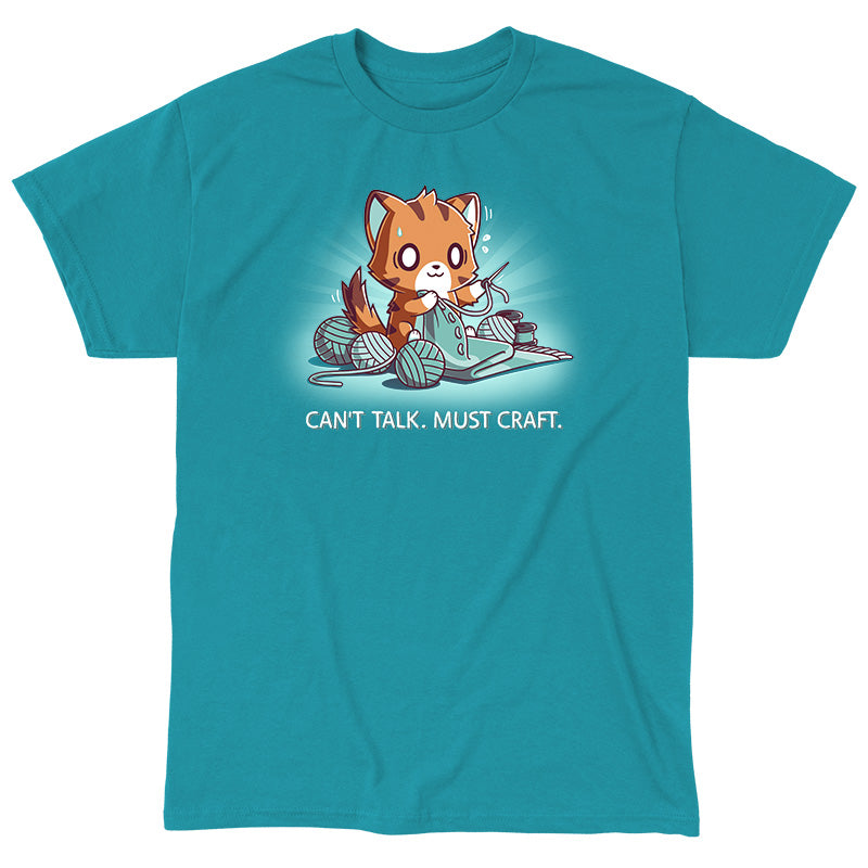 Classic Cotton T-shirt_TeeTurtle Can't Talk. Must Craft tropical blue t-shirt featuring a cat knitting with multiple yarn balls around and a concentrated expression. Text below reads "CAN'T TALK. MUST CRAFT."