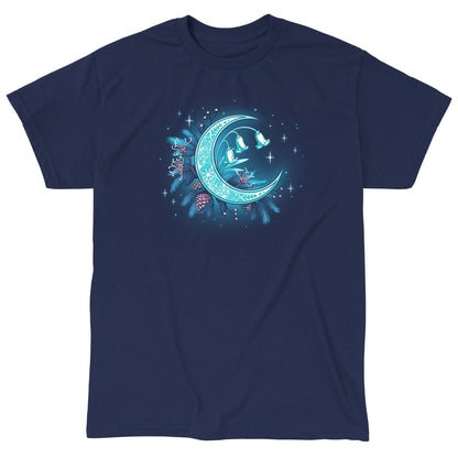 Classic Cotton T-shirt_TeeTurtle Winter Moon navy blue t-shirt featuring a magical glowing crescent moon adorned with floral patterns, bell flowers, pine cones, and evergreen branches against a dark celestial background. 