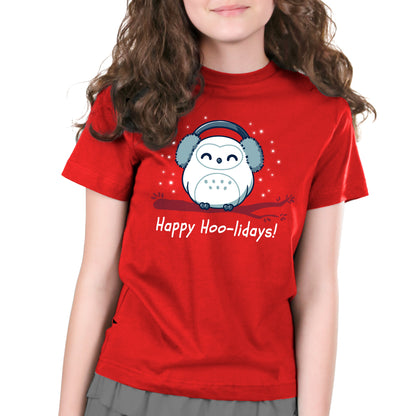 Premium Cotton T-shirt_TeeTurtle Happy Hoo-lidays red t-shirt featuring a cheerful snowy owl wearing earmuffs and sitting on a branch surrounded by falling snow.