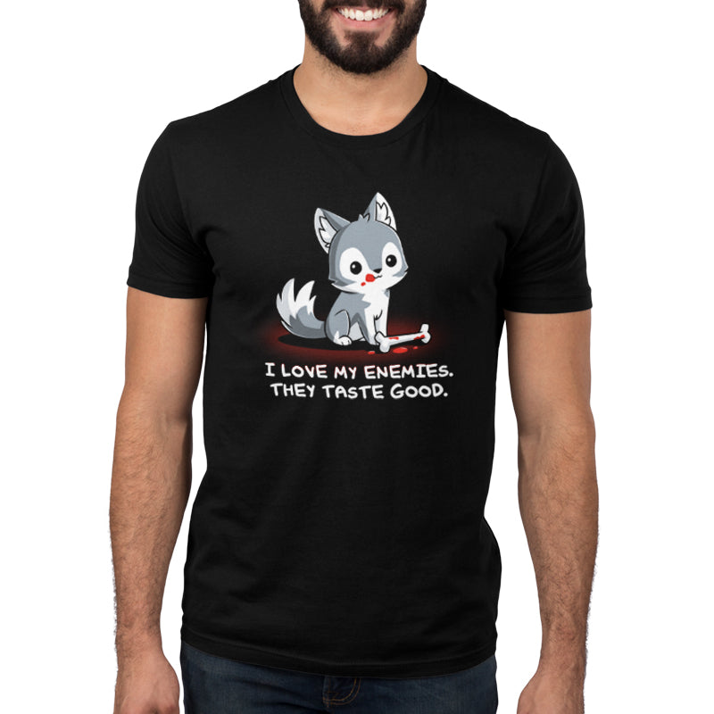 Premium Cotton T-shirt_TeeTurtle I Love My Enemies black t-shirt featuring wolf with blood on its muzzle holding a bone, accompanied by the text "I Love My Enemies. They Taste Good."