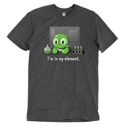 Premium Cotton T-shirt_A cartoon green turtle wearing glasses is in a lab with beakers and test tubes filled with green liquid. Text below reads, "I'm in my element." Wear this scene on an "I'm in My Element" apparel made from charcoal gray Super Soft Ringspun Cotton by monsterdigital.