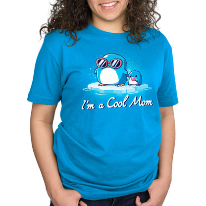 Premium Cotton T-shirt_TeeTurtle I'm a Cool Mom cobalt blue t-shirt featuring two penguins on ice, one wearing sunglasses.