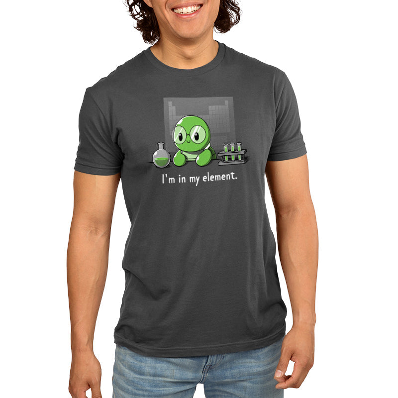 Premium Cotton T-shirt_A cartoon green turtle wearing glasses is in a lab with beakers and test tubes filled with green liquid. Text below reads, "I'm in my element." Wear this scene on an "I'm in My Element" apparel made from charcoal gray Super Soft Ringspun Cotton by monsterdigital.