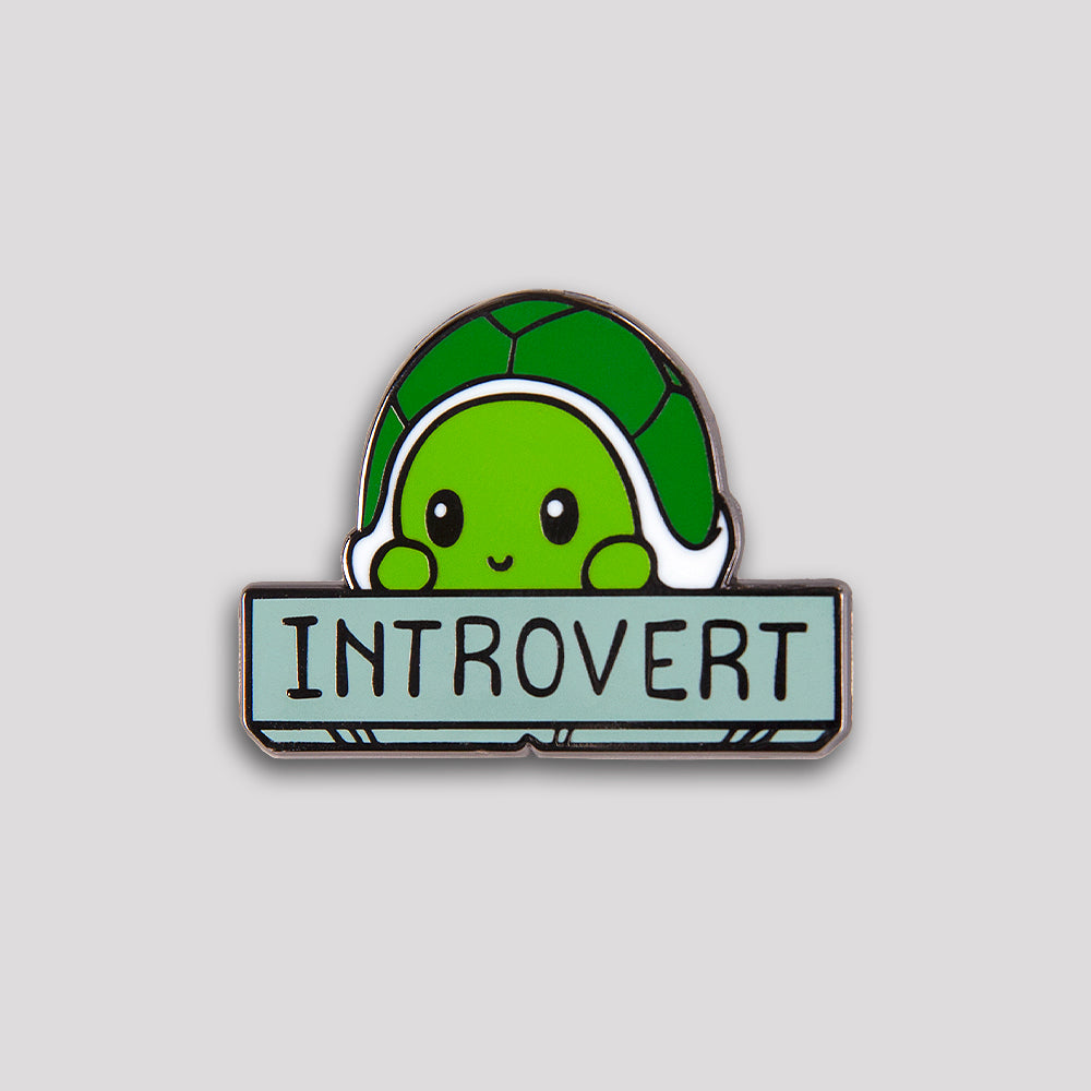 A green enamel Introvert Pin by TeeTurtle for introverts.