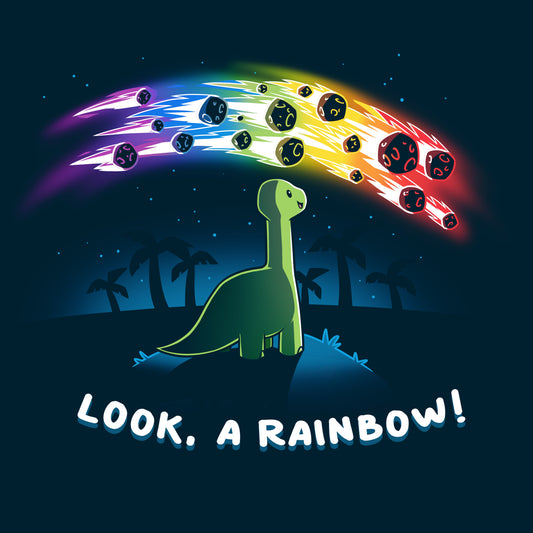 Premium Cotton T-shirt_TeeTurtle Look, a Rainbow! navy blue t-shirt featuring a green dinosaur looking up at rainbow asteroids in the starry night sky. The background is filled with black palm trees in the distance being illuminated from the asteroids, with 