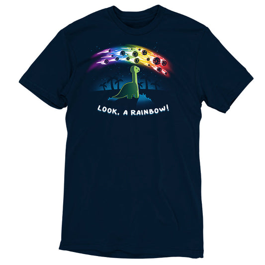 Premium Cotton T-shirt_TeeTurtle Look, a Rainbow! navy blue t-shirt featuring a green dinosaur looking up at rainbow asteroids in the starry night sky. The background is filled with black palm trees in the distance being illuminated from the asteroids, with 