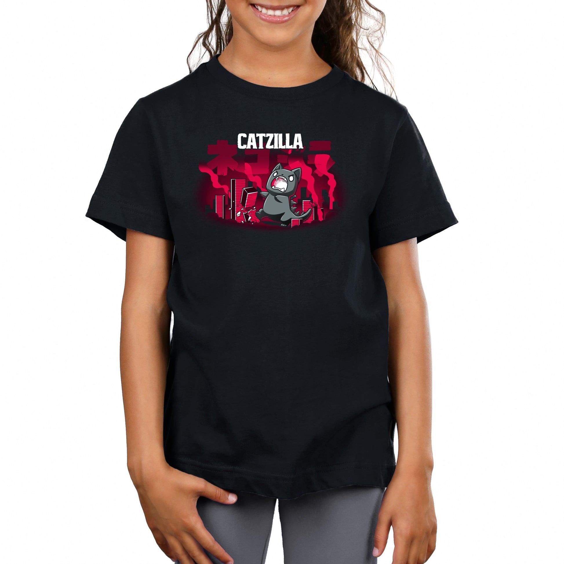 Premium Cotton T-shirt_TeeTurtle Catzilla black t-shirt featuring an illustration of an angry gray cat terrorizing a city knocking down red, blocky buildings with reddish-pink smoke filling the air and "Catzilla" written above the graphic. The text beneath the word CATZILLA resembles Japanese characters or simplified Chinese characters.