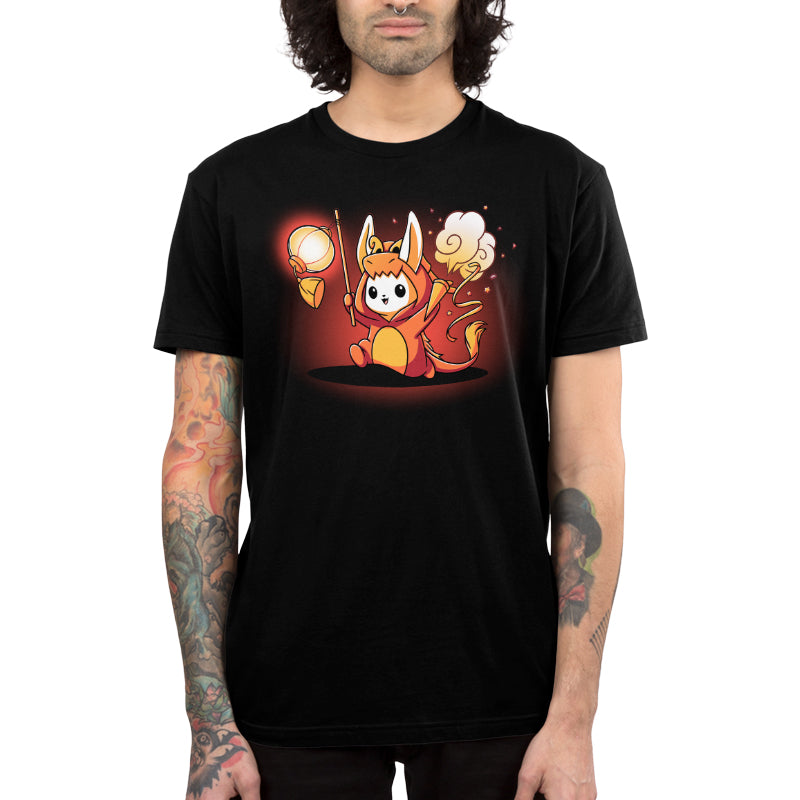 Premium Cotton T-shirt_TeeTurtle Year of the Dragon Kigurumi black t-shirt featuring a white bunny dressed in an orange dragon costume while holding party favors surrounded by orange stars.