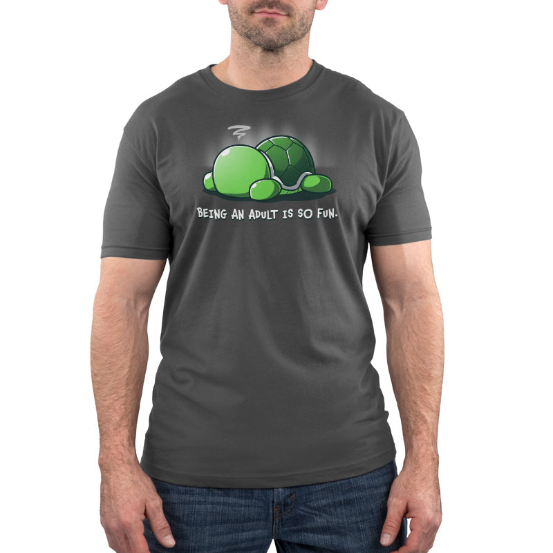 Premium Cotton T-shirt_TeeTurtle Being an Adult is So Fun Charcoal Gray t-shirt featuring a cartoon turtle lying face down with a stressed expression, accompanied by the text "Being an adult is so fun." 