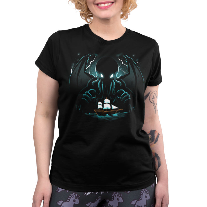 Premium Cotton T-shirt_TeeTurtle Epic Cthulhu black t-shirt featuring the fictional cosmic creature Cthulhu hovering over a brown ship with whites sails in the  in the stormy, dark sea.