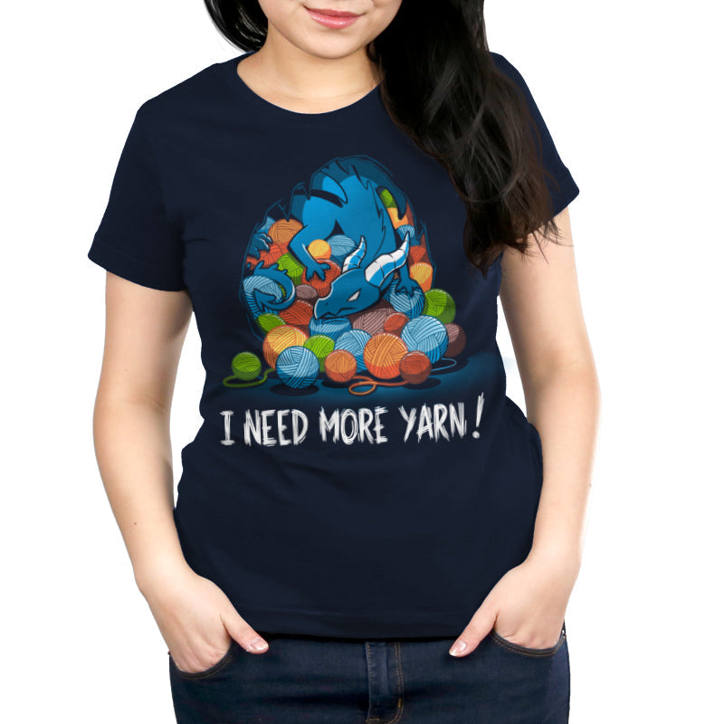 Premium Cotton T-shirt_TeeTurtle Yarn Hoarder navy blue t-shirt featuring a blue dragon sitting on top of a pile of multi-colored yarn balls. The words "I NEED MORE YARN!" are written underneath the illustration.