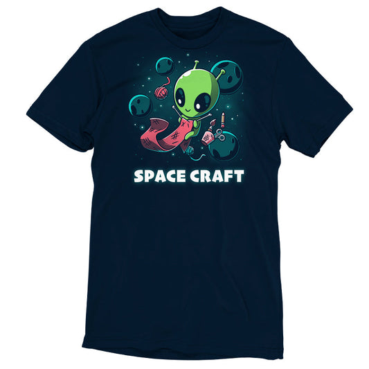 Premium Cotton T-shirt_TeeTurtle Space Craft navy blue t-shirt featuring an illustration of a green alien knitting a red scarf in space surrounded by planets, stars, balls of yarn, and a cup holding scissors, a paint brush and floating pencil. The words 