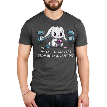 Premium Cotton T-shirt_TeeTurtle Battle Scars charcoal gray t-shirt featuring a determined cartoon rabbit holding a hot glue gun, surrounded by sewing supplies and mannequins, with the text "My battle scars are from intense crafting" below.