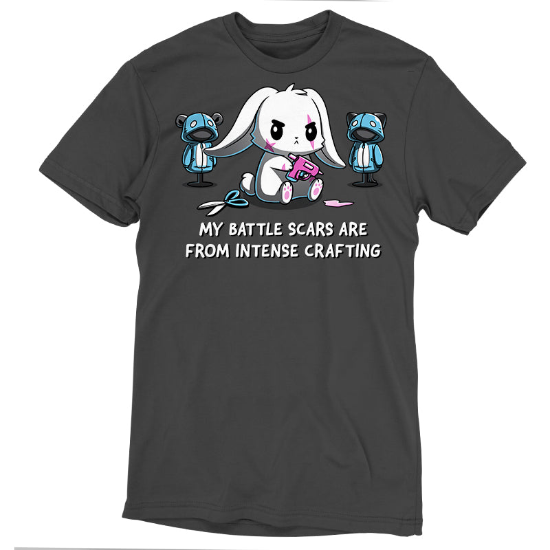 Premium Cotton T-shirt_TeeTurtle Battle Scars charcoal gray t-shirt featuring a determined cartoon rabbit holding a hot glue gun, surrounded by sewing supplies and mannequins, with the text "My battle scars are from intense crafting" below.