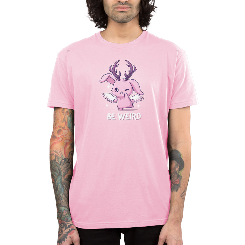 Premium Cotton T-shirt_TeeTurtle light pink Be Weird t-shirt featuring a winking wolpertinger.