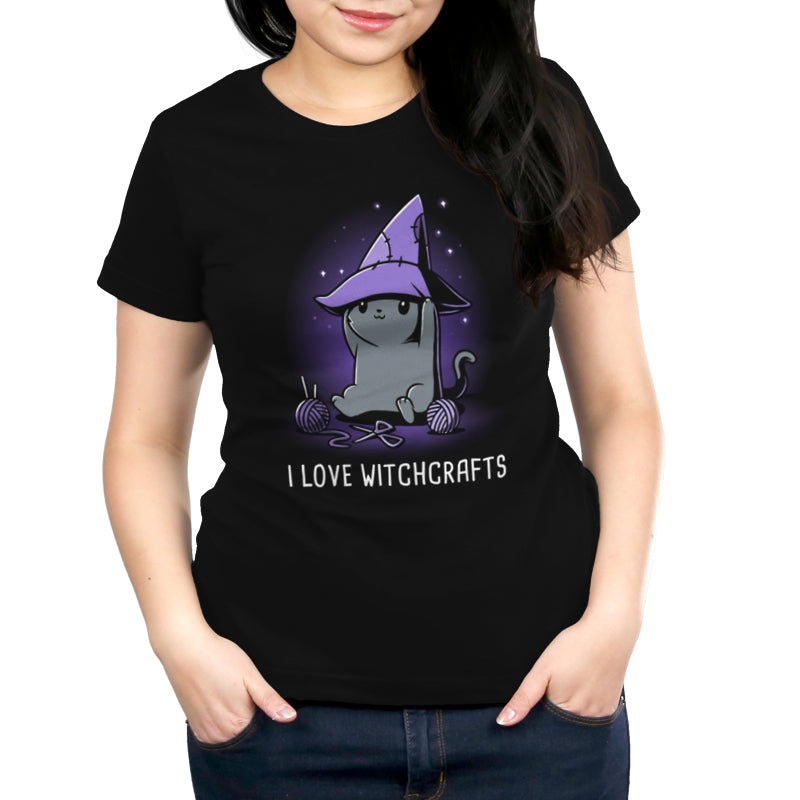 Premium Cotton T-shirt_TeeTurtle Crafty Kitty black t-shirt featuring a cheerful gray cat wearing a witches hat and crafting.