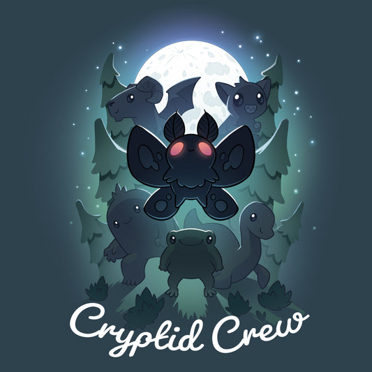 Premium Cotton T-shirt_TeeTurtle Cryptid Crew denim t-shirt featuring a whimsical illustration of six cartoon cryptids, including a mothman and a jackalope, in a forest with a full moon in the background. Text at the bottom reads 