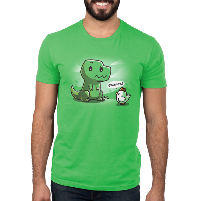 Premium Cotton T-shirt_Teeturtle Family Reunion apple green t-shirt   featuring a cartoon dinosaur with a puzzled expression sitting in front of a baby chick asking "Grandpa?" on a green background with faint scenery. 