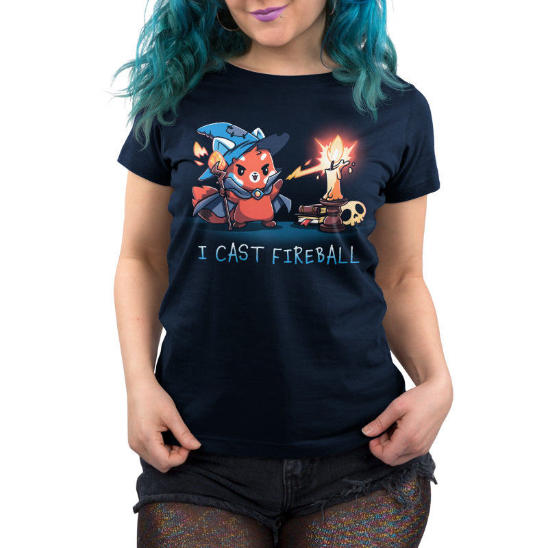 Premium Cotton T-shirt_TeeTurtle I Cast Fireball navy blue t-shirt featuring a fox in a tabletop game wizard outfit with a staff who casts a fireball spell towards a candle, with the text "I CAST FIREBALL" below. A stack of books and a skull are in the background. 